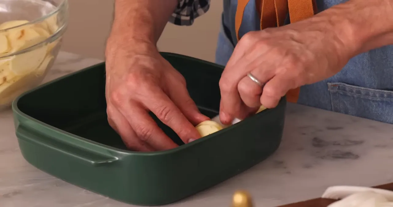 Potatoes and onions layered in baking dish