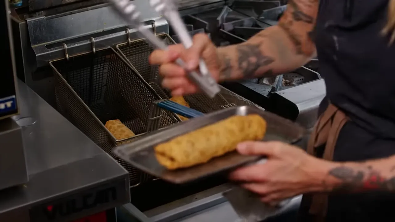 Golden-brown Rye Reuben Egg Rolls frying and bubbling