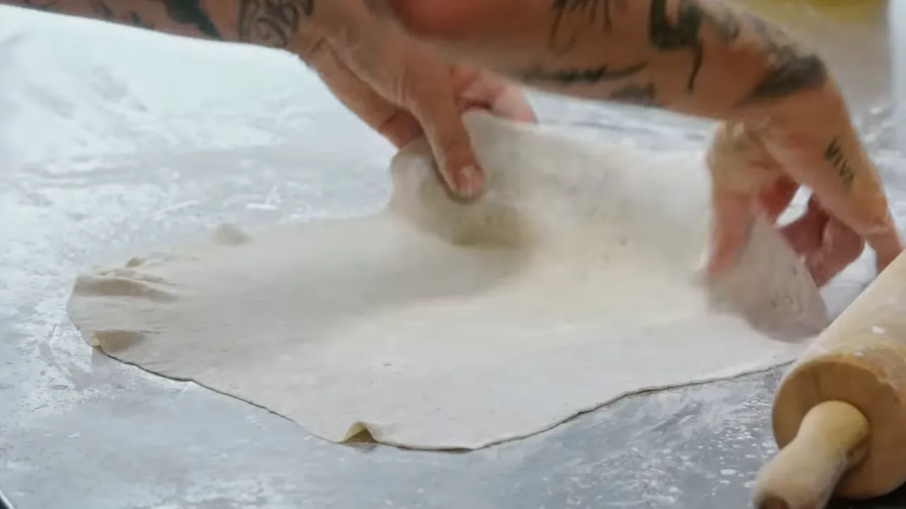 Rolling out rye-infused wonton wrappers to one eighth inch thickness