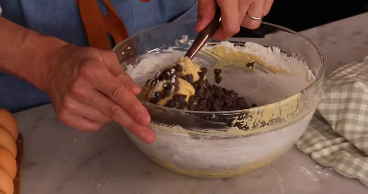 Adding chocolate chips to the batter