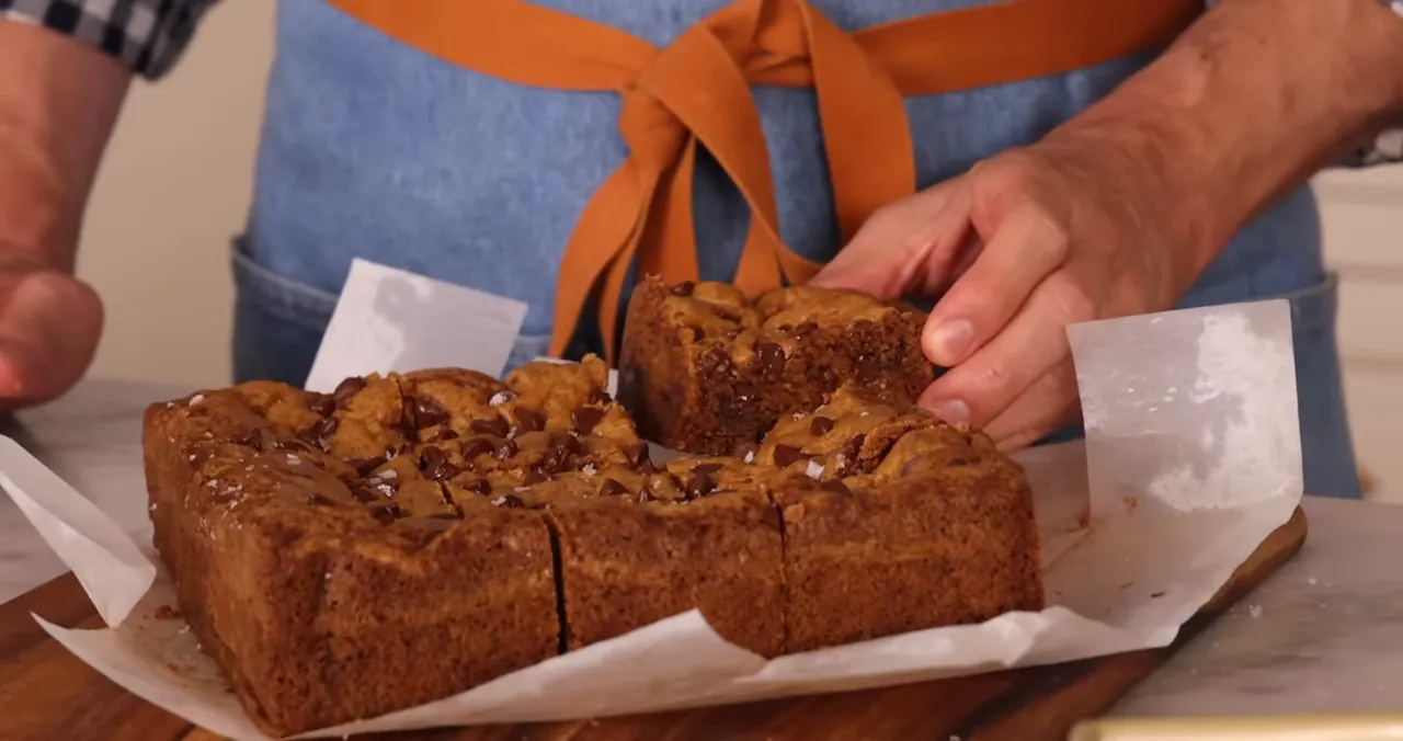 Baked cookie bars cooling and cut on a board