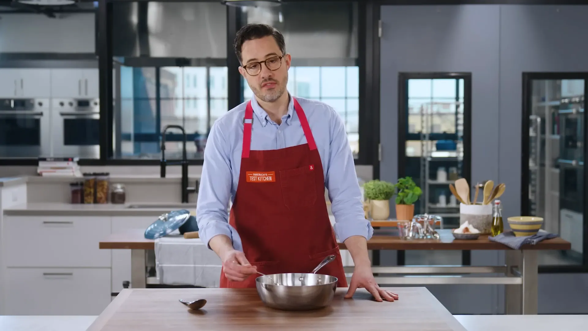 Sauce spoon resting in rounded sided pan