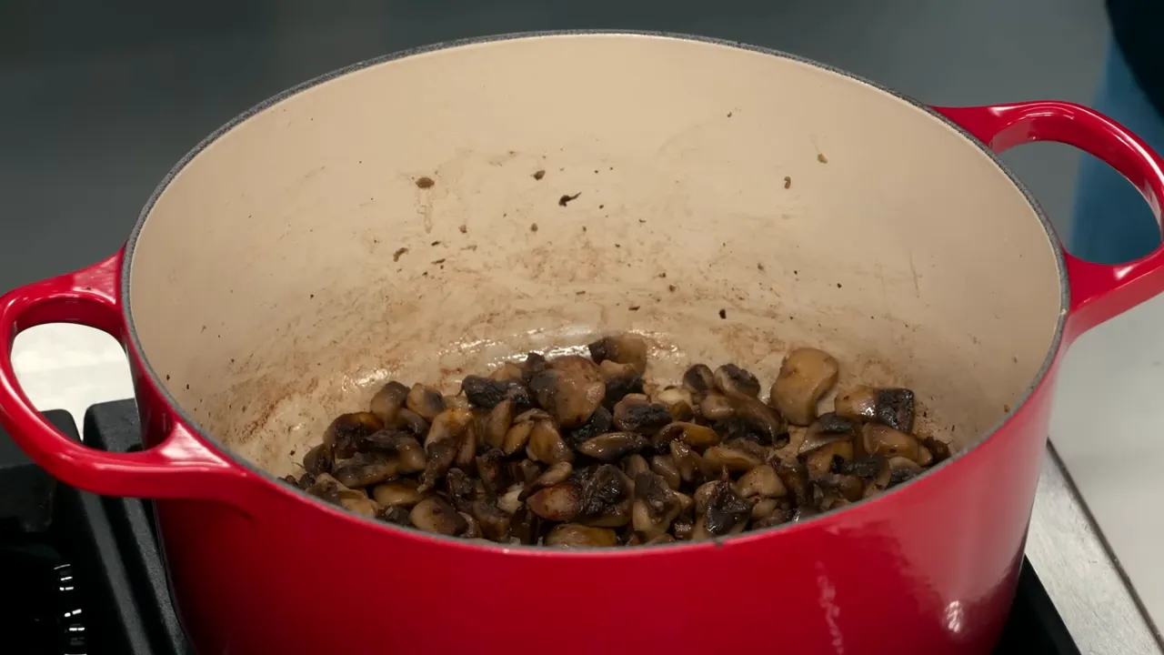 Mushrooms reduced and browning in the Dutch oven