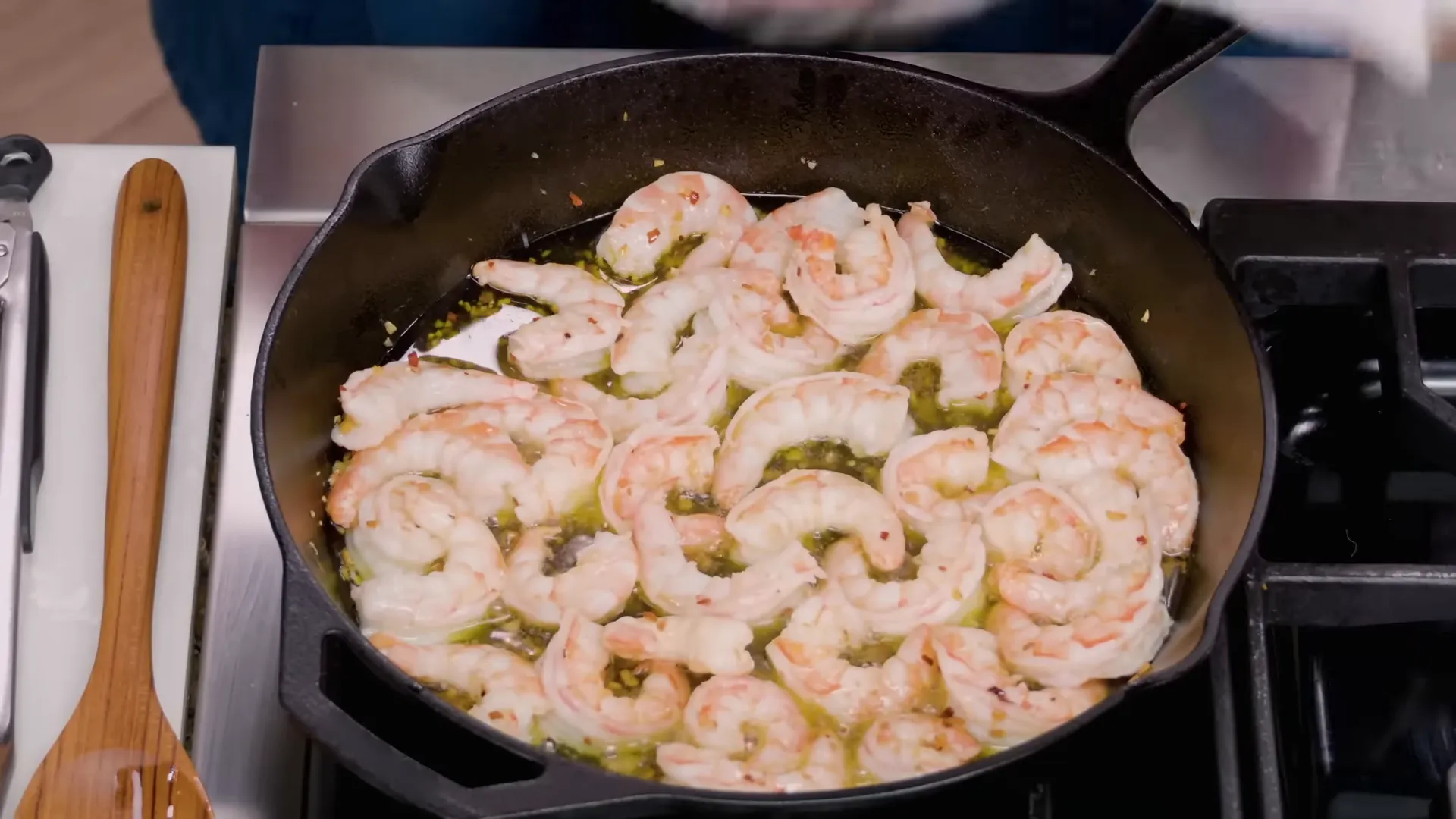 Finished gambas al ajillo garnished with parsley served in a hot skillet