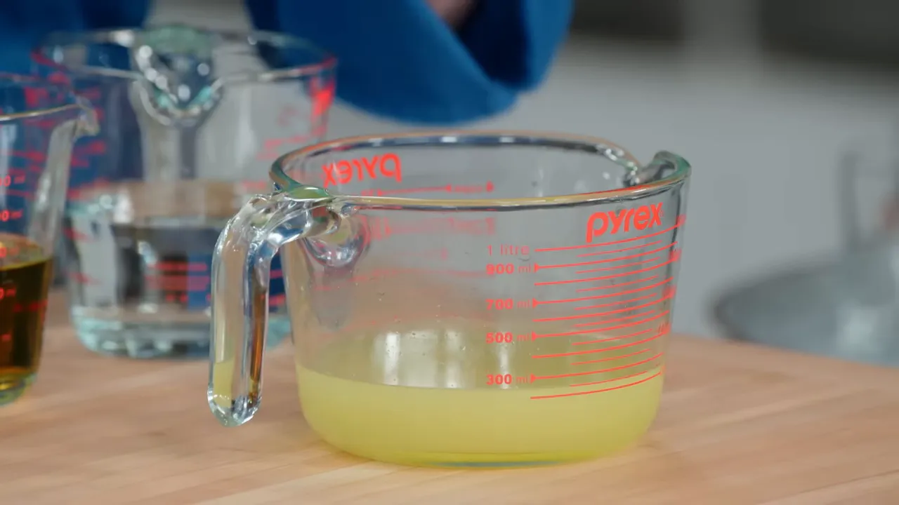 Mixing the strained lemon and lime juice for the margarita