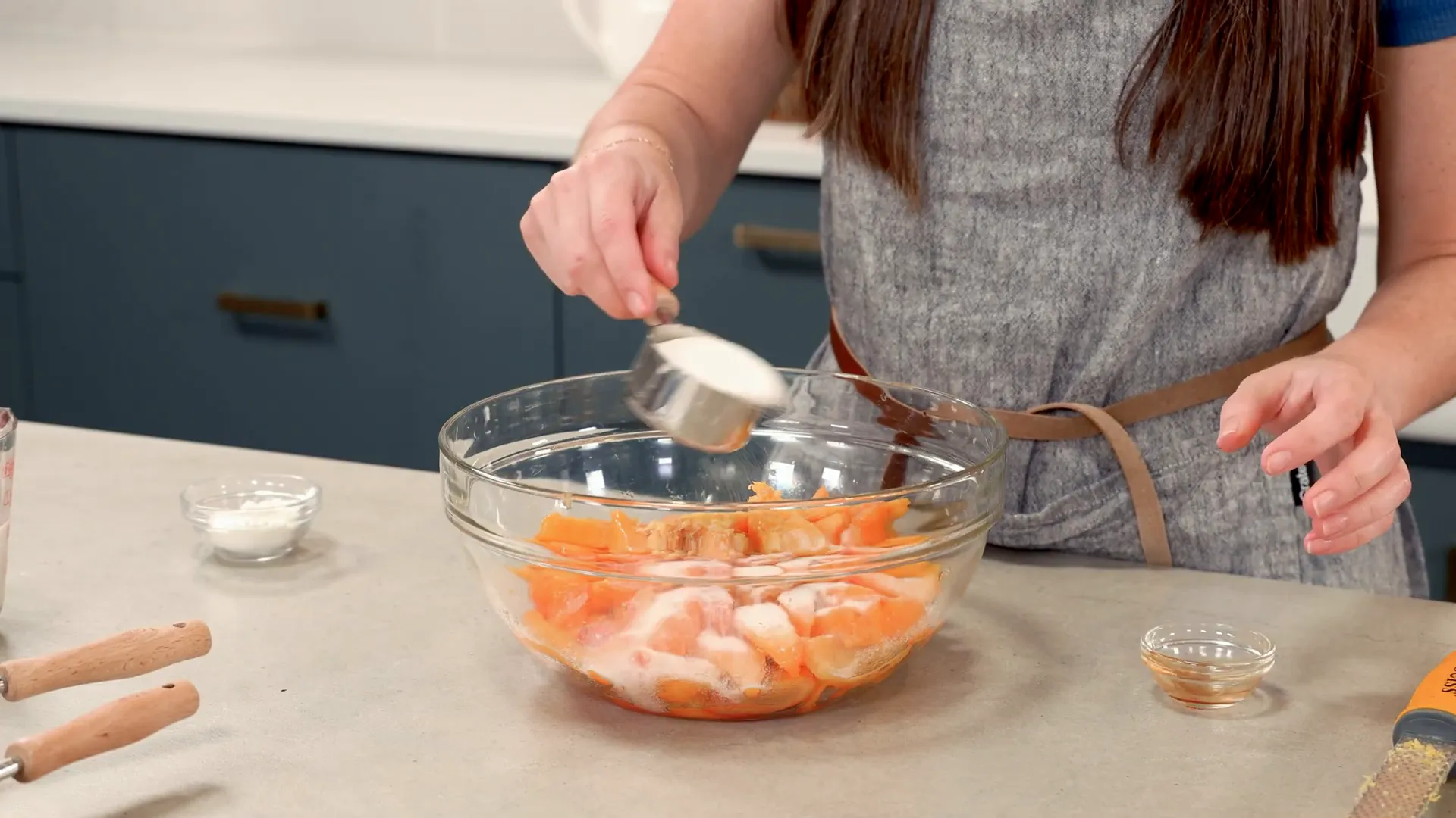 Mixing peaches with lemon zest, juice, sugar, vanilla, and cornstarch