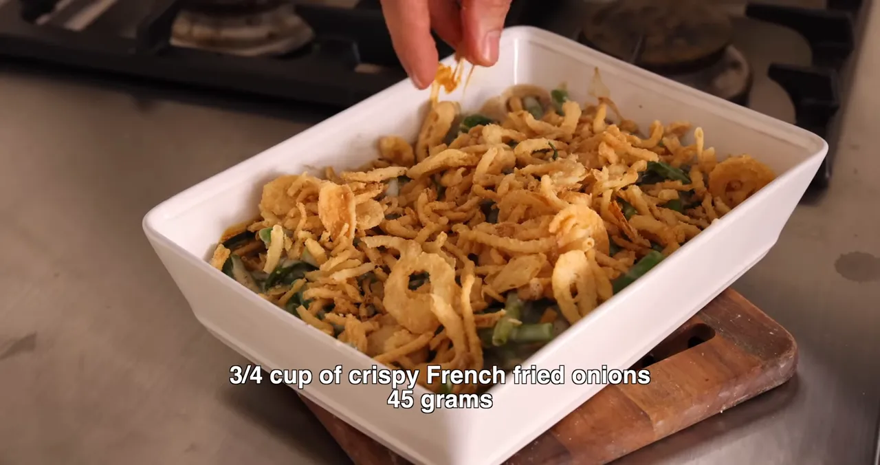 finished green bean casserole in a white dish topped with crispy fried onions