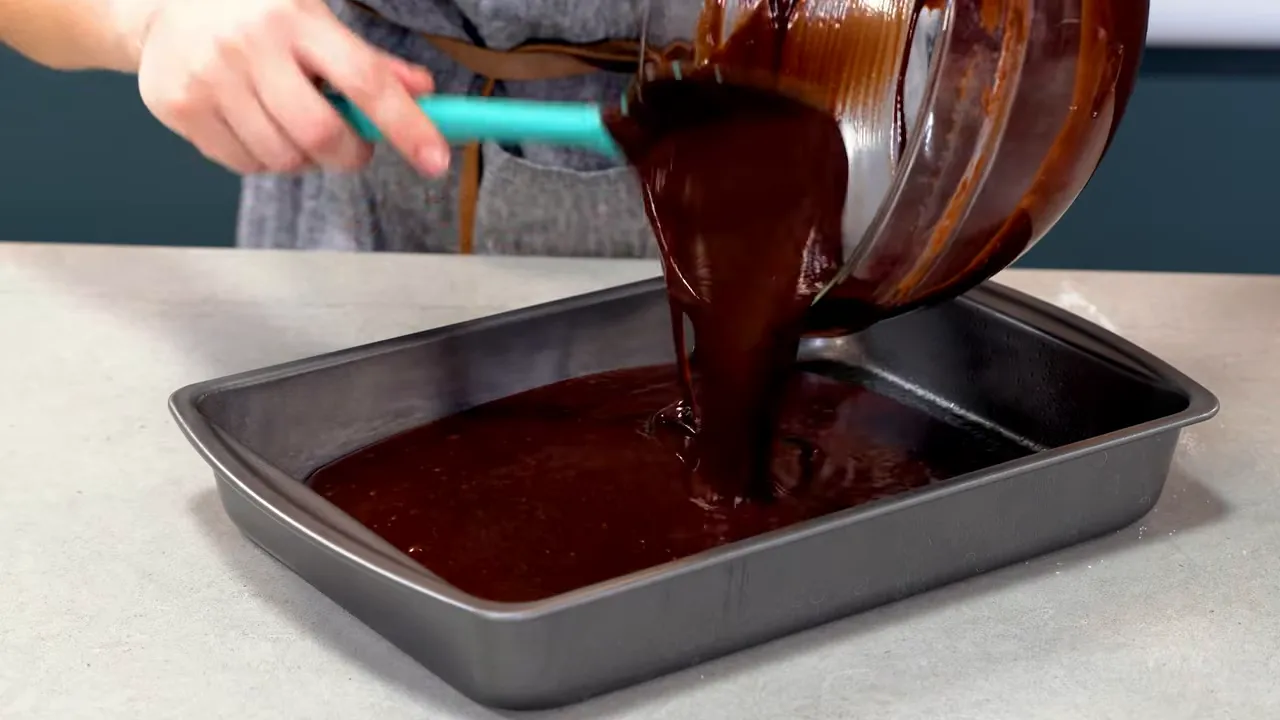 Cake batter poured into a 9x13 pan ready for baking