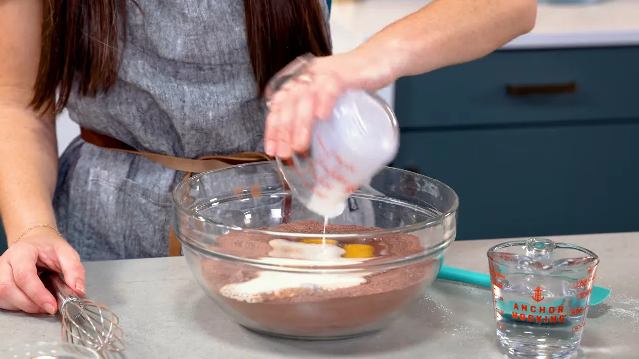 Adding wet ingredients to the one-bowl chocolate cake