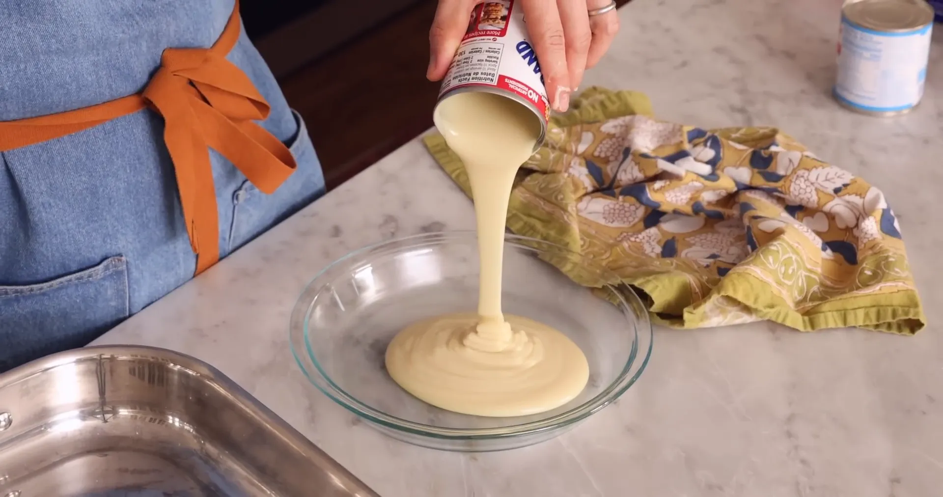 Sweetened condensed milk poured into a pie dish ready for baking