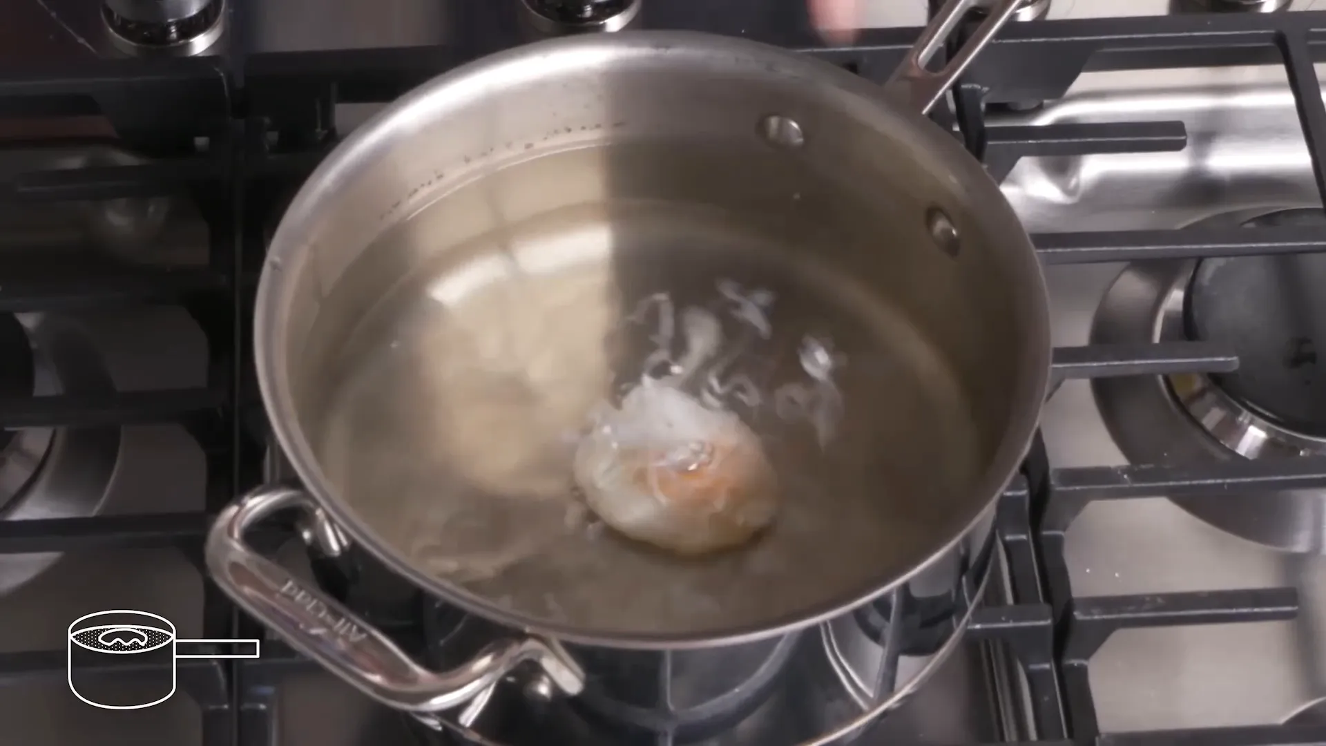 Perfectly poached egg in simmering water