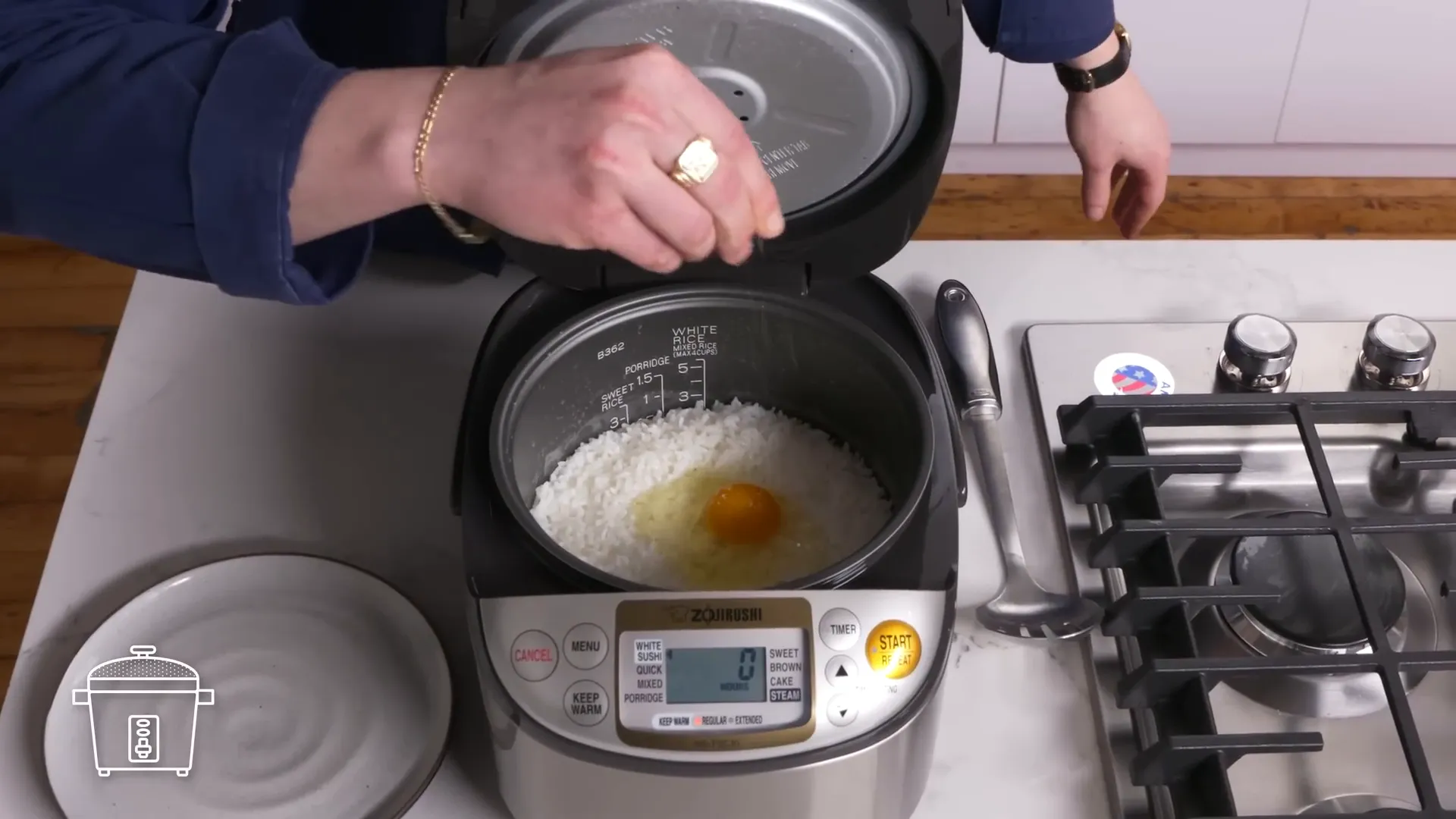 Egg cooking in a rice cooker on top of rice