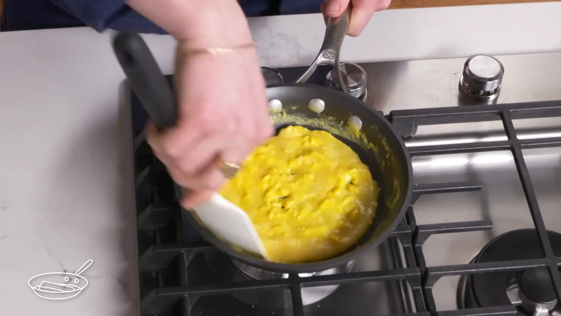 French omelette being rolled in a pan