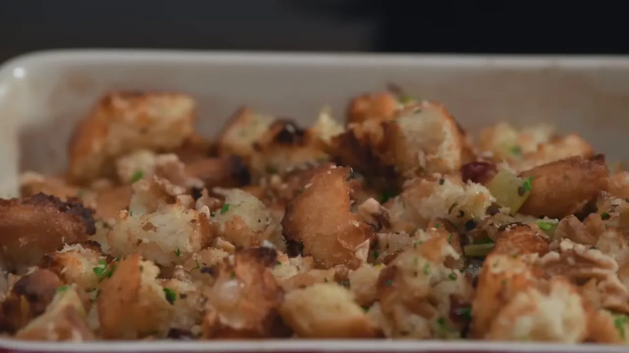 close-up finished rustic baguette stuffing topped with parsley and toasted walnuts