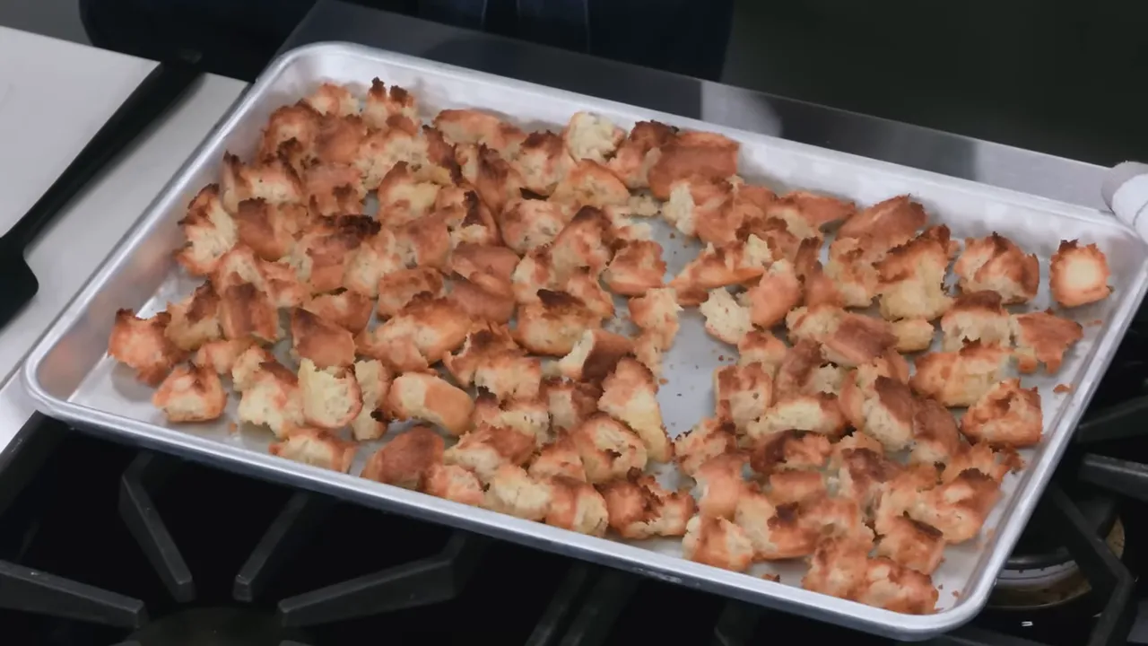 toasted baguette pieces on a rimmed sheet ready for stuffing