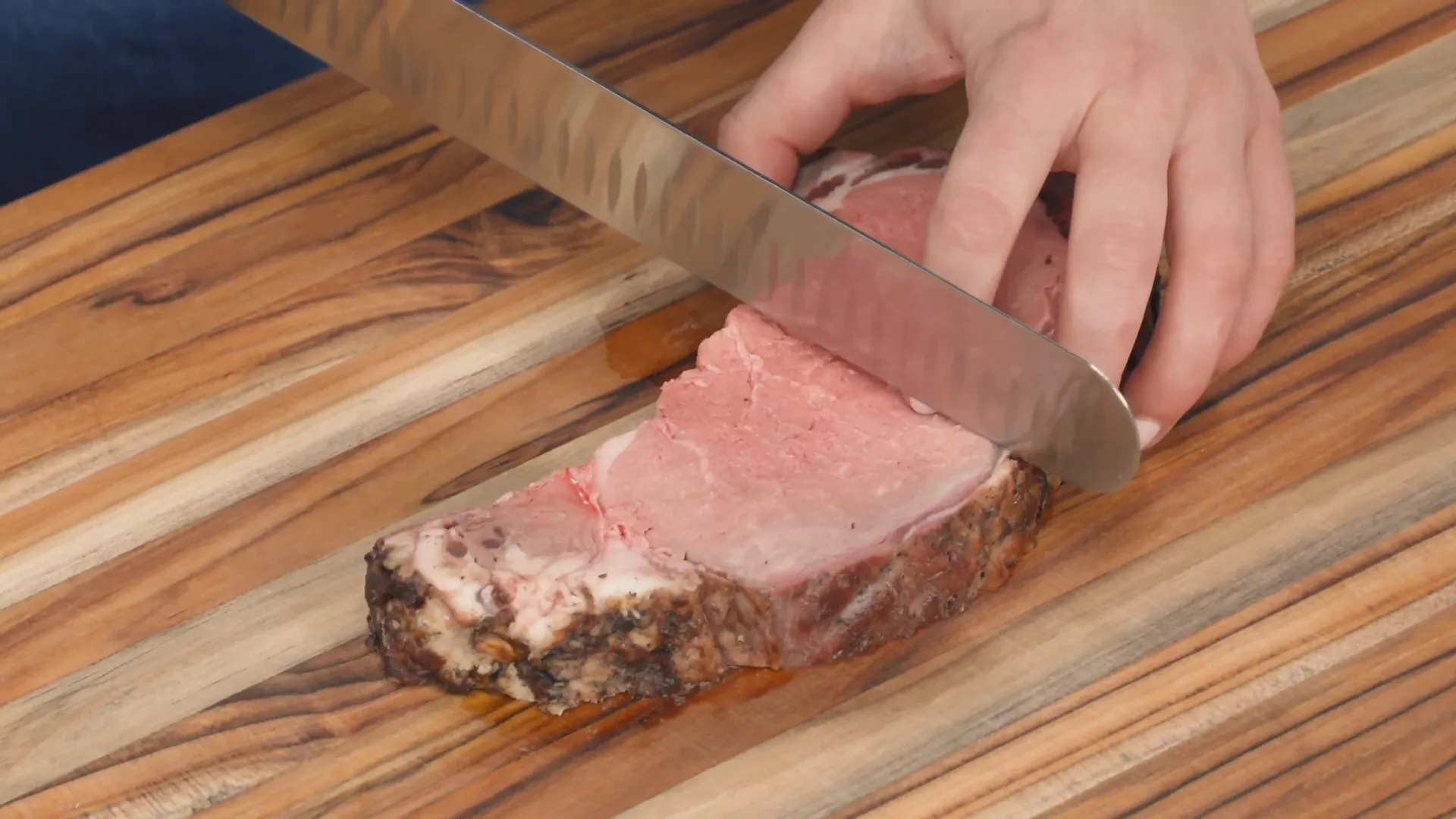 Slicing cold smoked prime rib on a bias