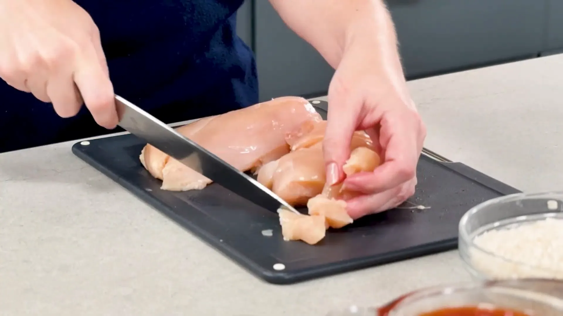 Cutting chicken into bite-sized pieces