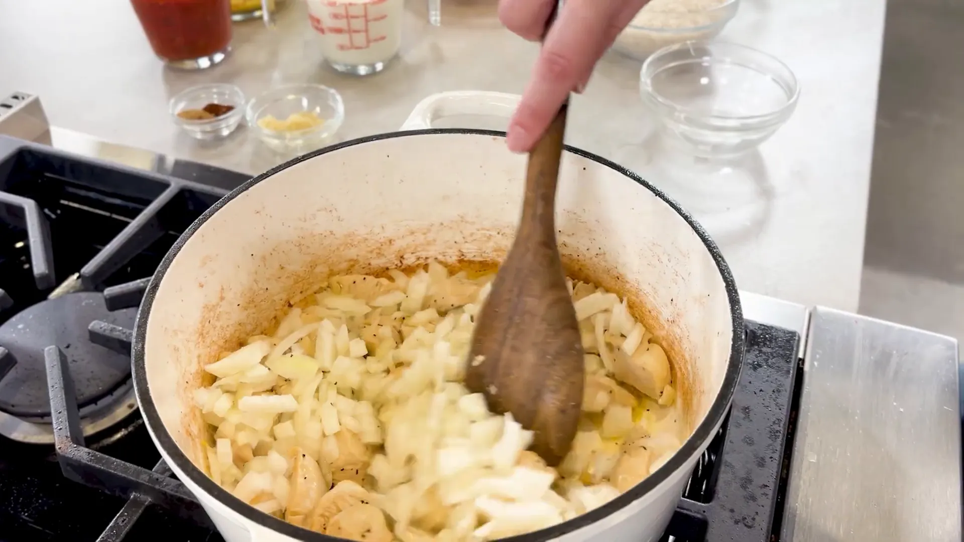 Browning chicken and cooking onions in pot