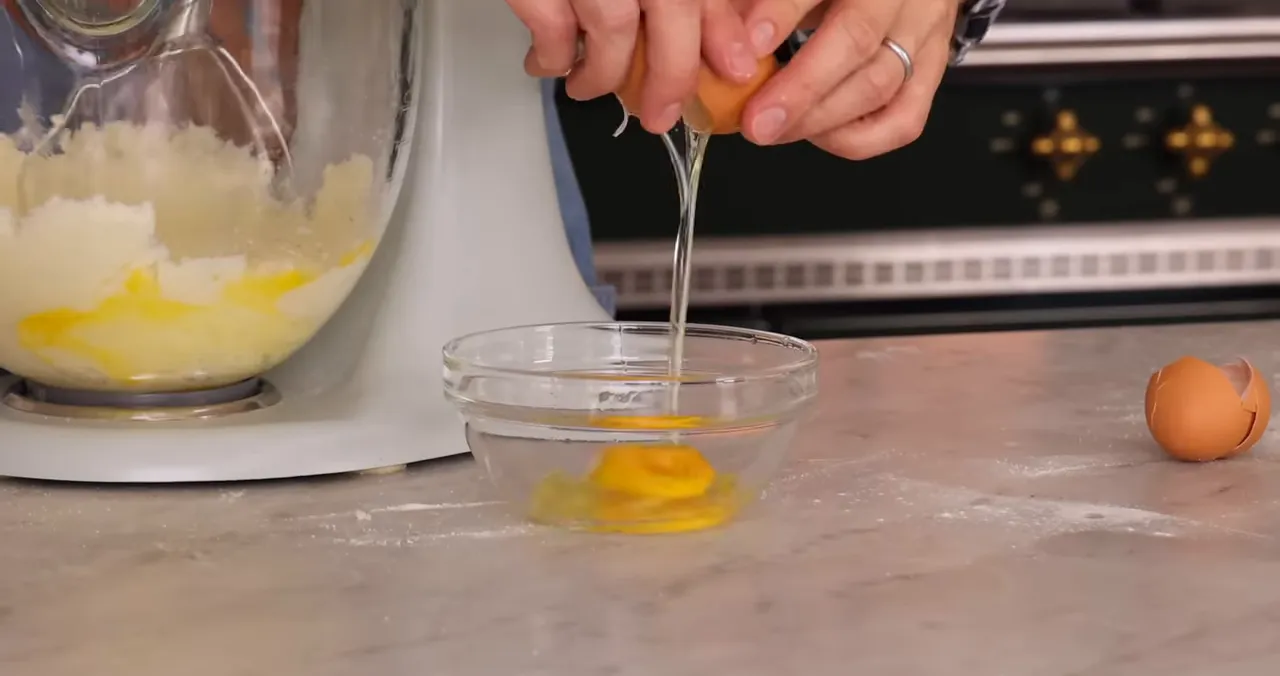 Adding eggs to the batter