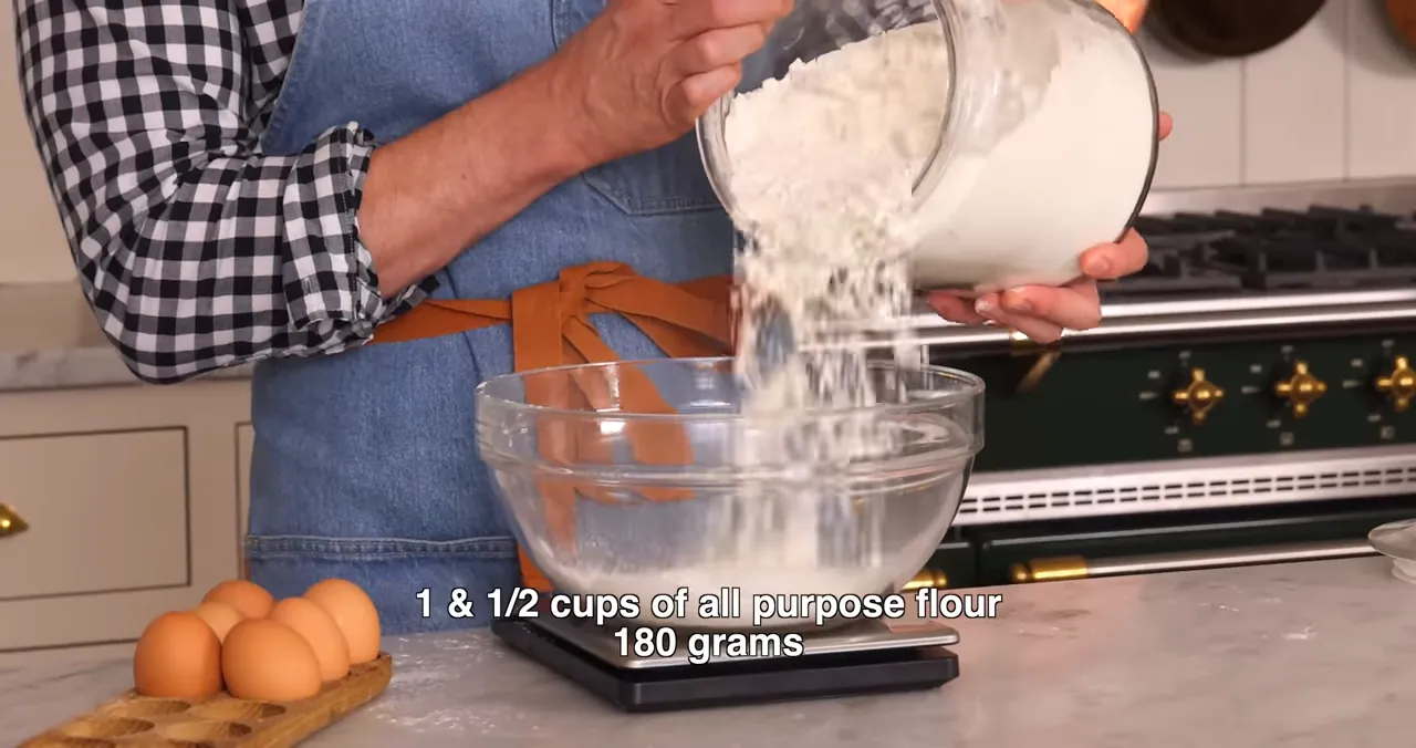 Measuring flour and adding to a large bowl