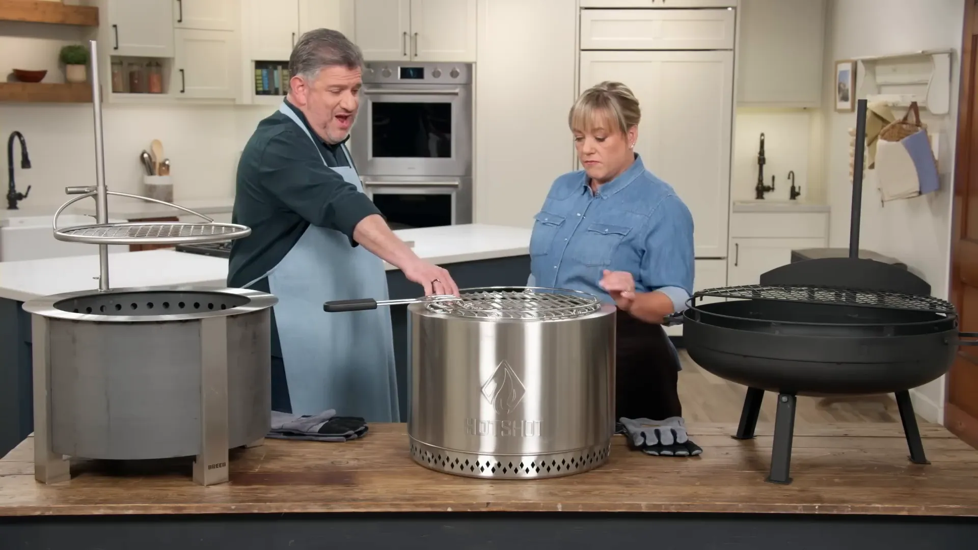 Tester arranging logs diagonally in a mid-size fire pit