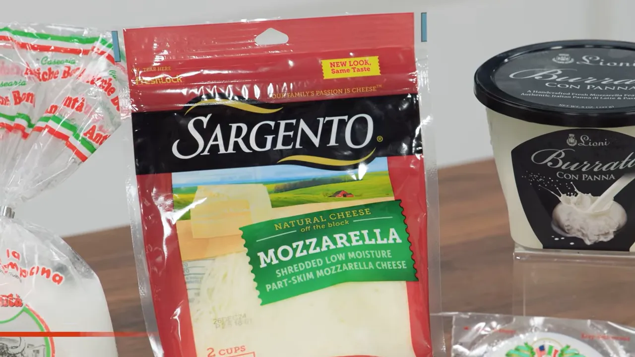 Close-up of packaged mozzarella and a tub labeled Burrata con Panna on a counter