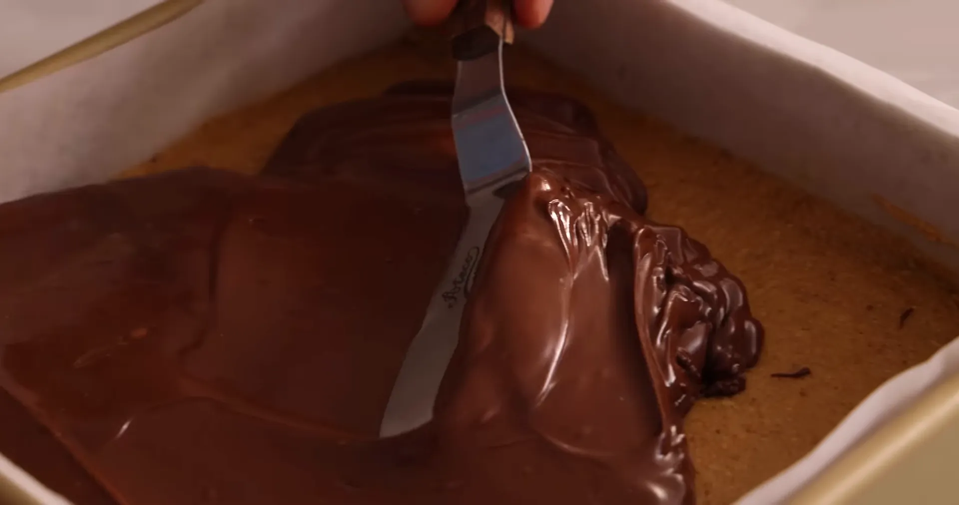 Pouring and smoothing the chocolate topping