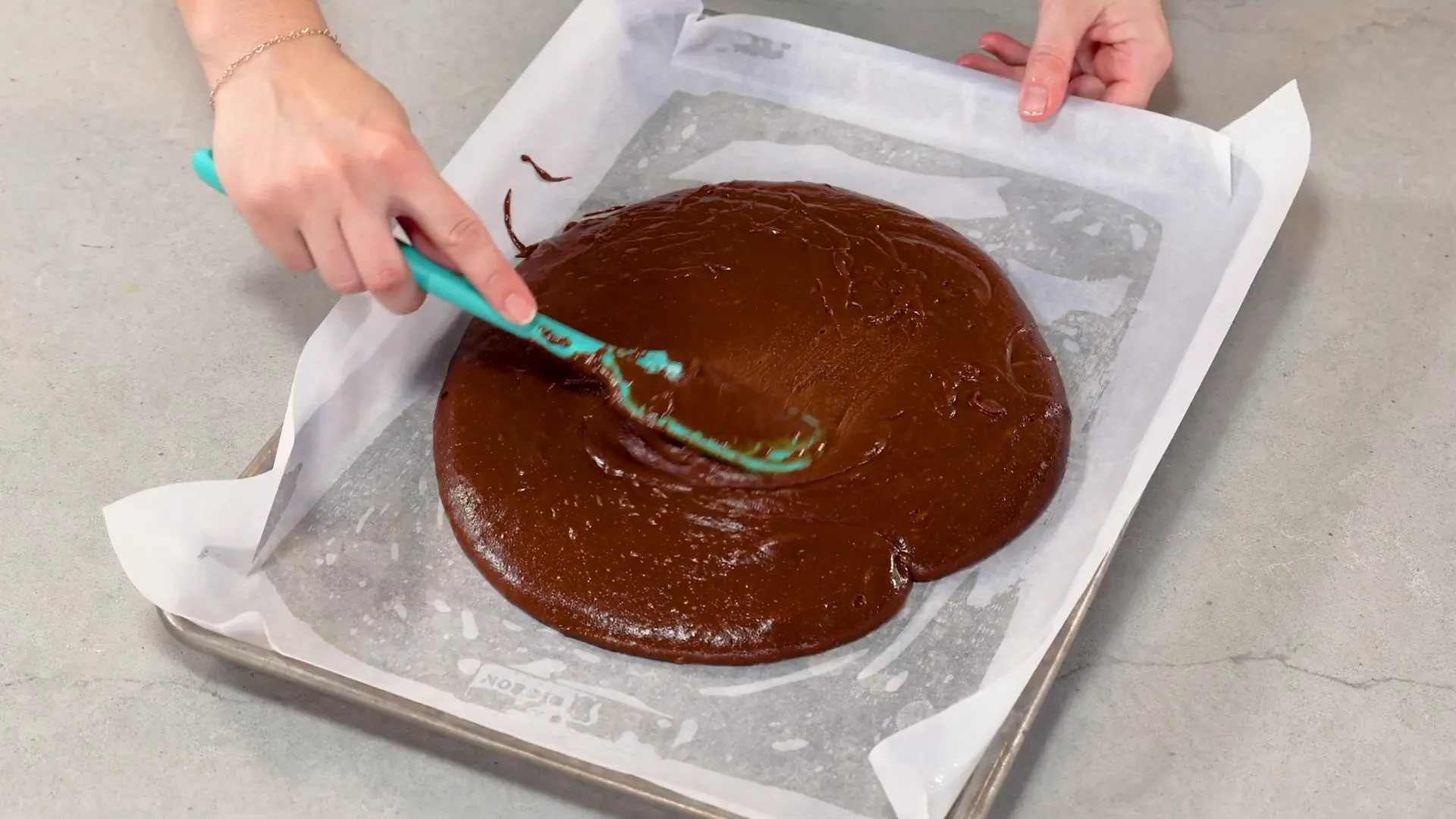 Brownie batter spread evenly in the sheet pan