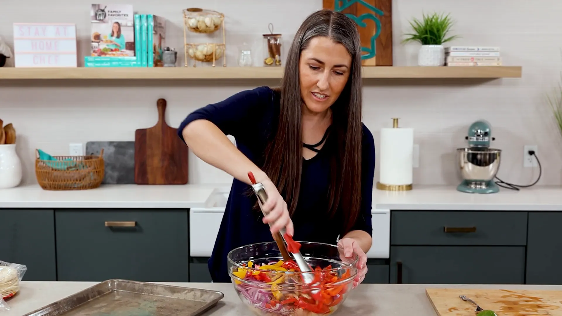 Mixing sliced chicken and colorful peppers with seasoning