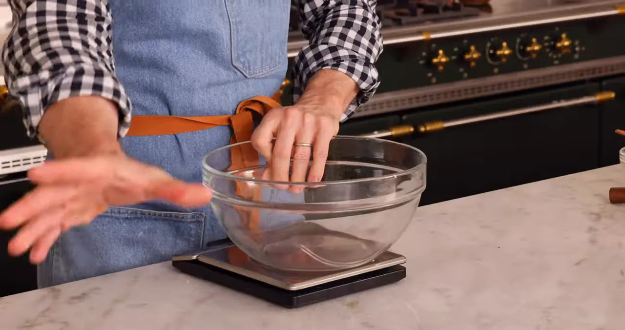 Mixing wet ingredients in a bowl with apple cider reduction