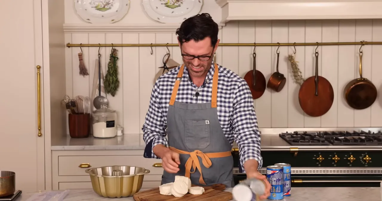Bundt pan, biscuit pieces and cans on a kitchen counter ready for assembly