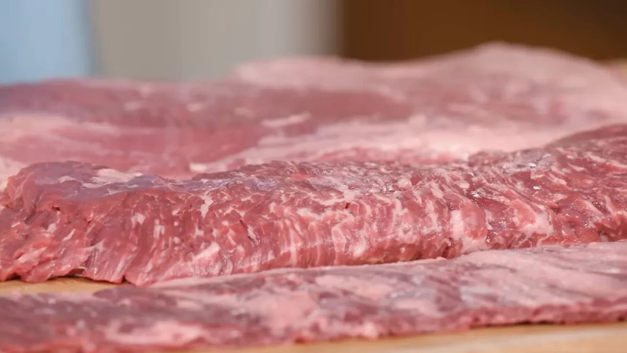 Close-up of flank and skirt steaks highlighting pronounced grain and marbling