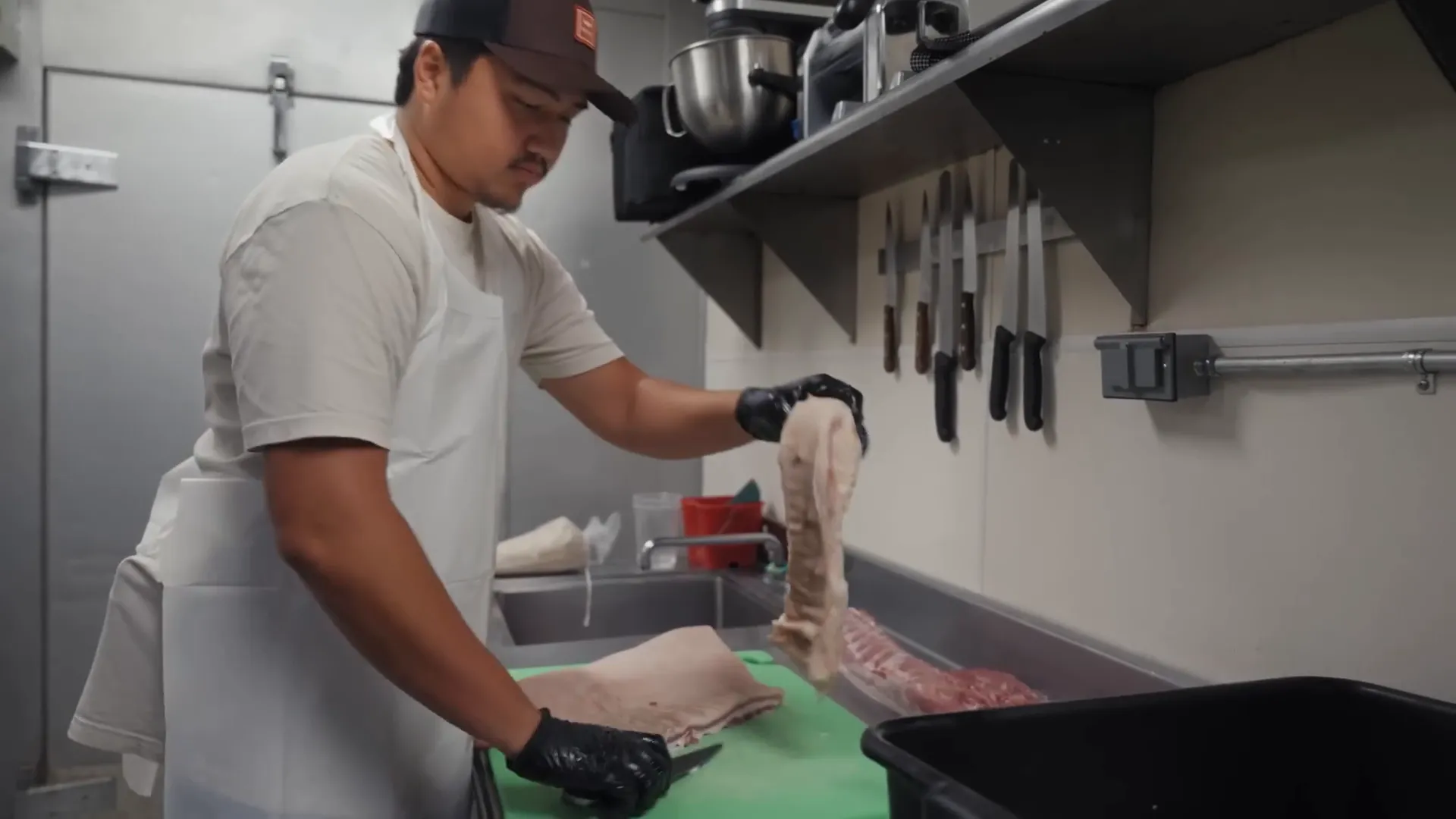 Chef Keanu and Owen butchering a Berkshire pig in the kitchen
