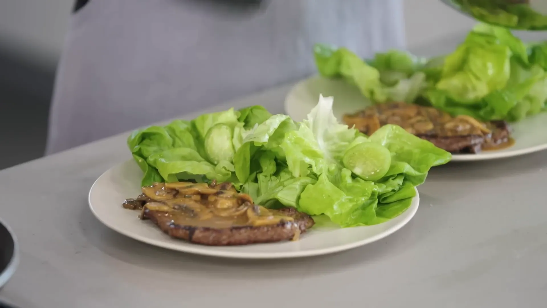 Plated minute steaks with mushroom gravy and tomatillo salad ready to enjoy