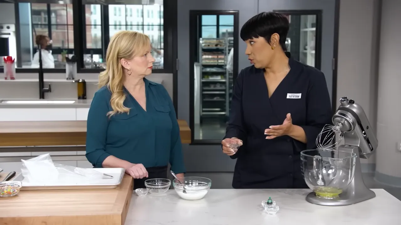 kitchen counter with stand mixer, bowls of sugar, small prep bowls, piping bag and sprinkles