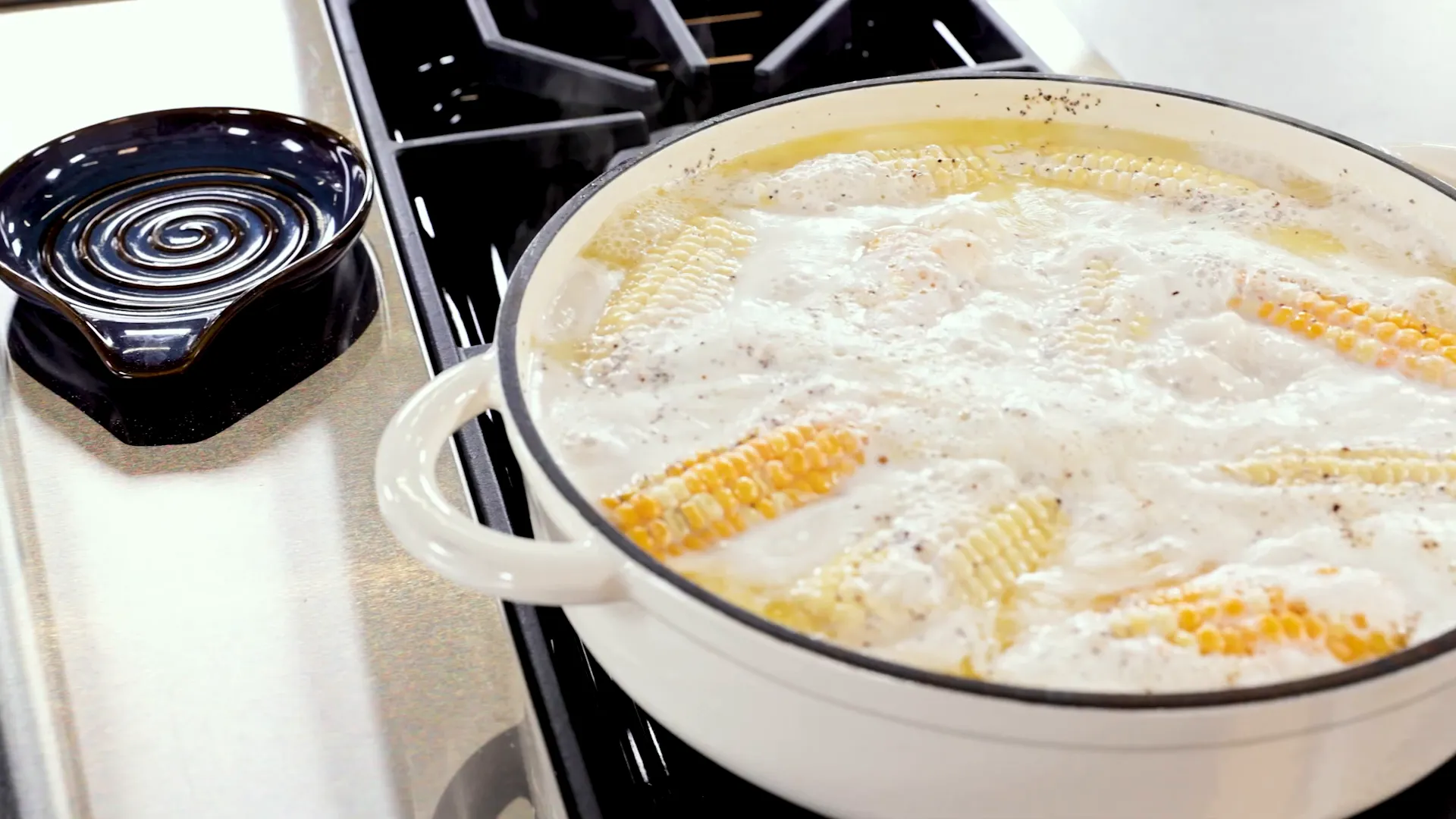 Corn simmering in buttery milk bath