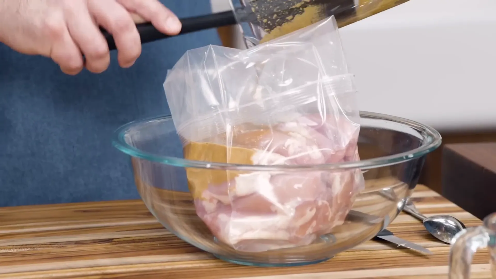 Chicken thighs marinating in zipper lock bag