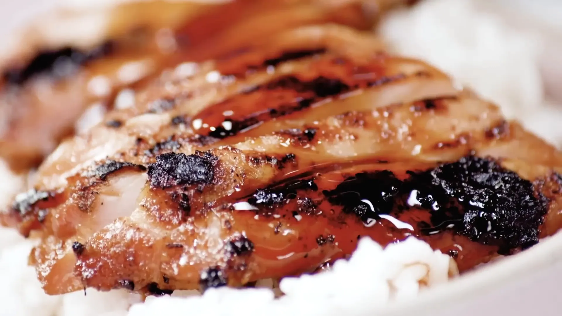 Sliced chicken teriyaki ready to serve with rice and coleslaw