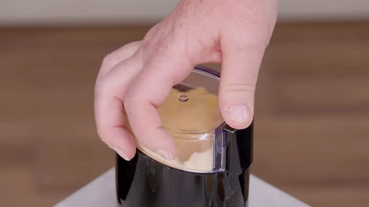 Grinding cornmeal to a finer powder for the coating