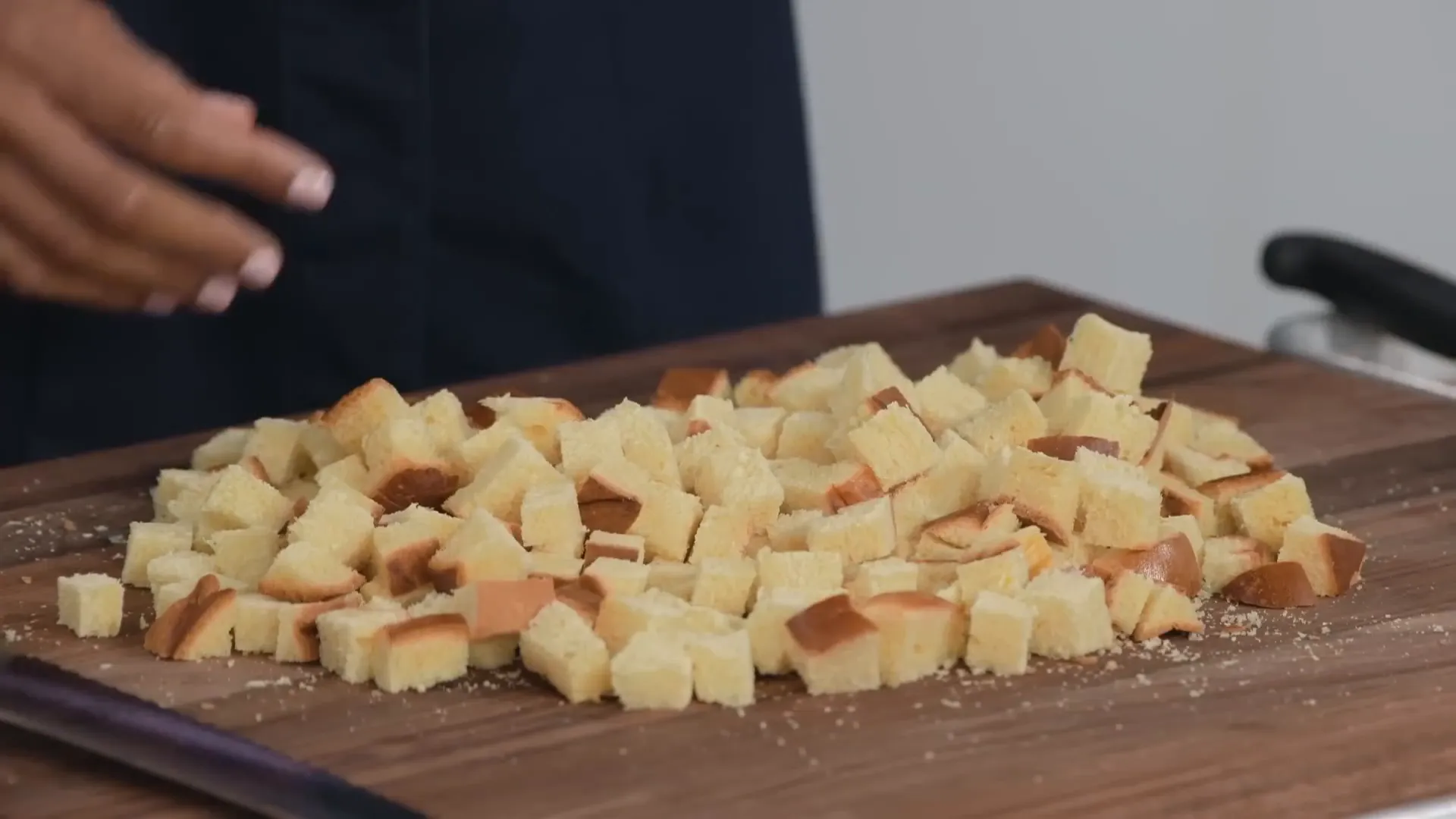Challah bread cut into half-inch cubes on the cutting board
