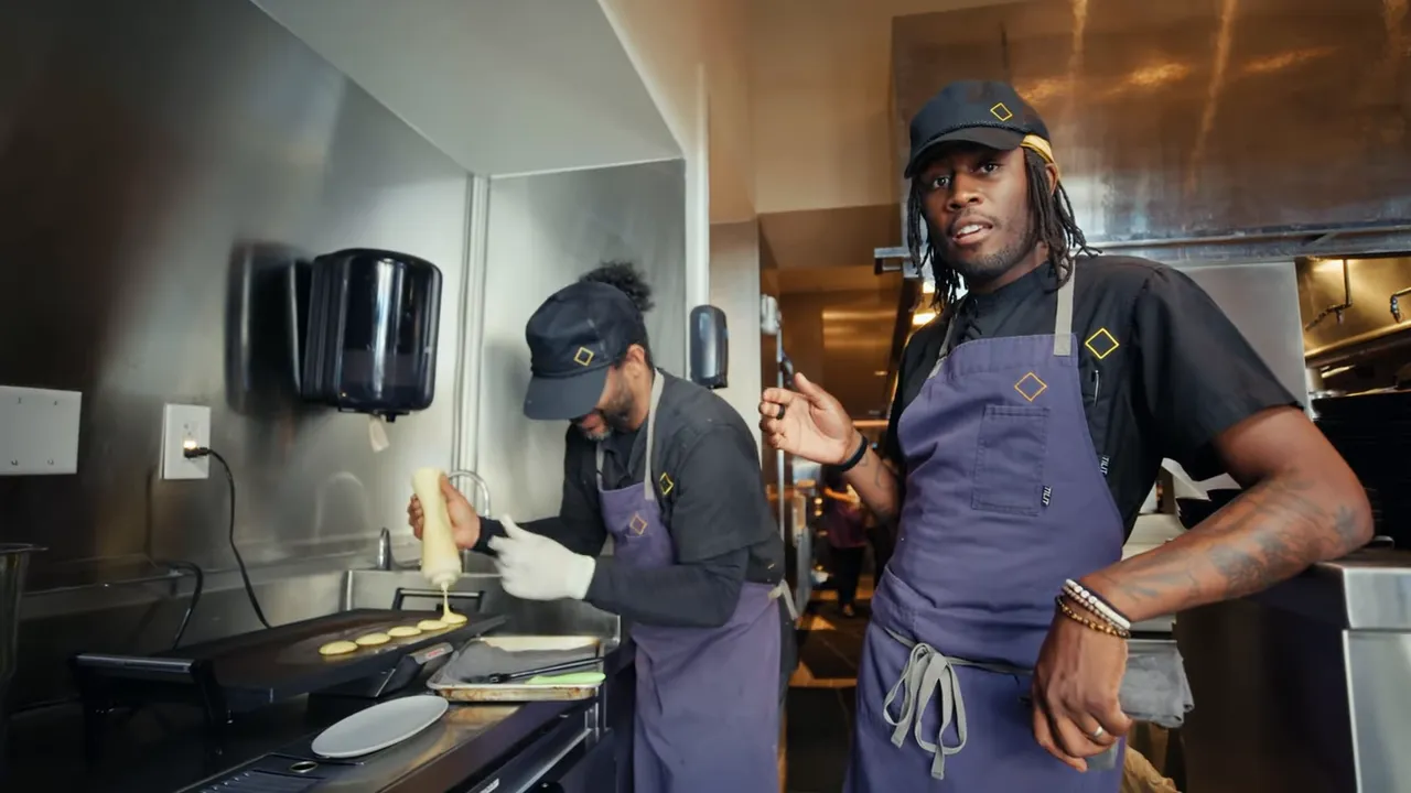 Chef and team tasting plantain hoe cakes with buttered Maryland blue crab