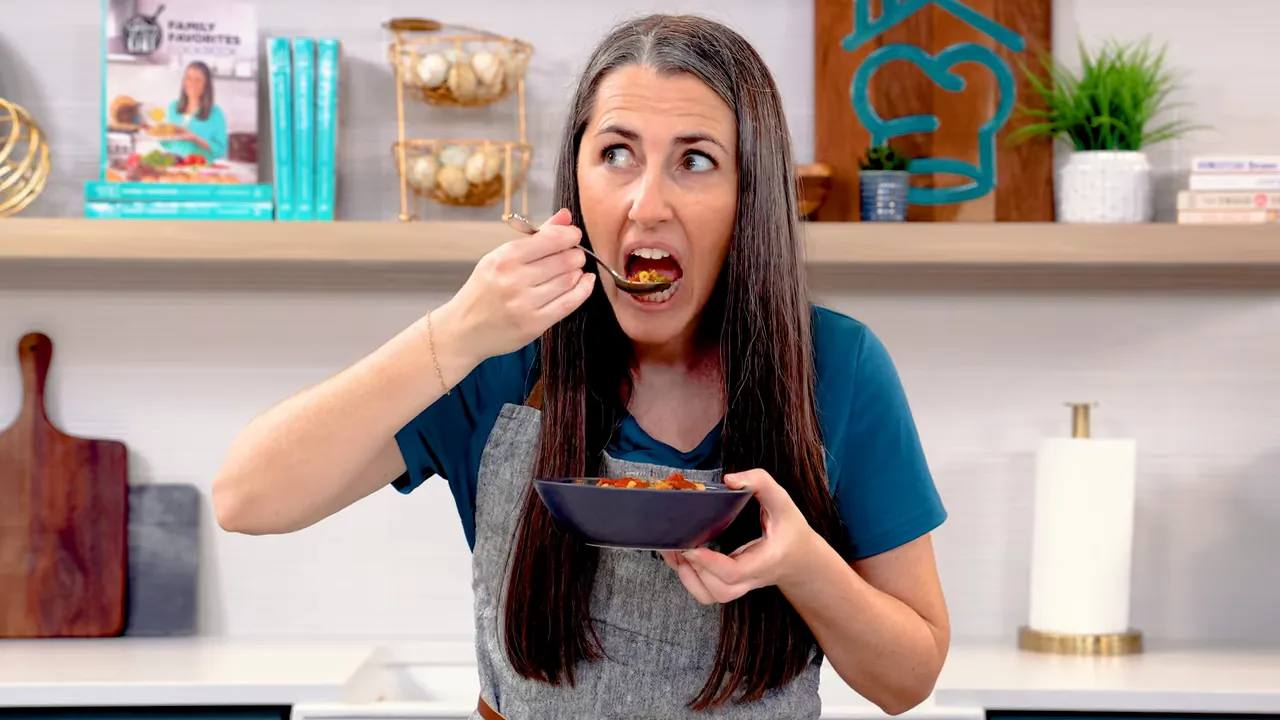 Finished bowl of pasta e fagioli topped with Parmesan and basil