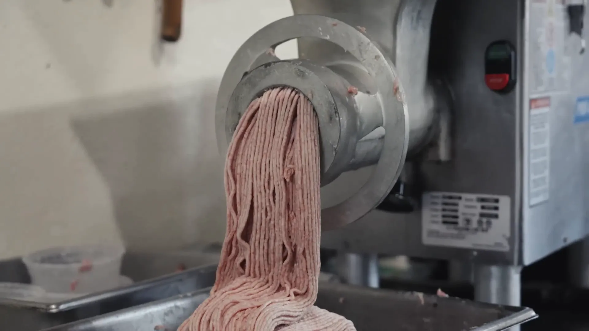 Grinding and seasoning pork trim to make local Spam