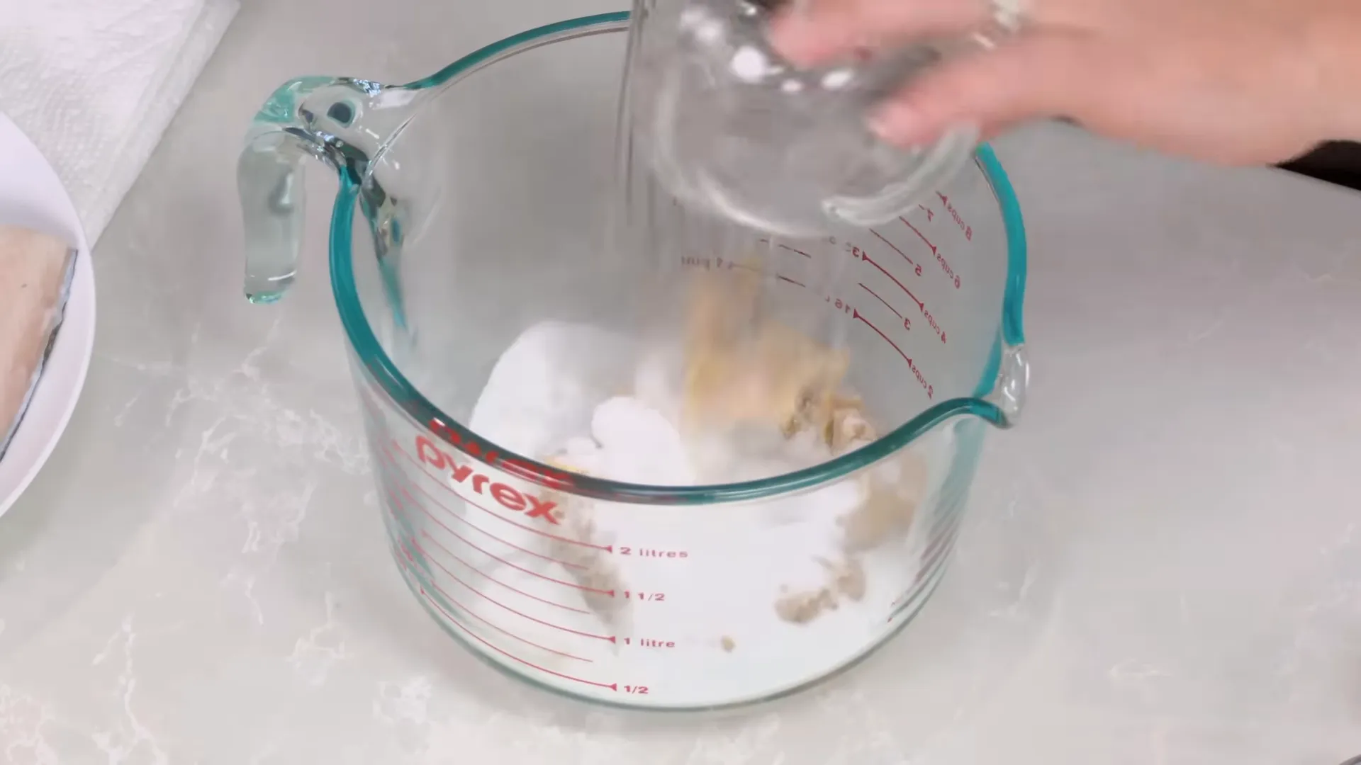 Measuring white miso and sugar into a bowl