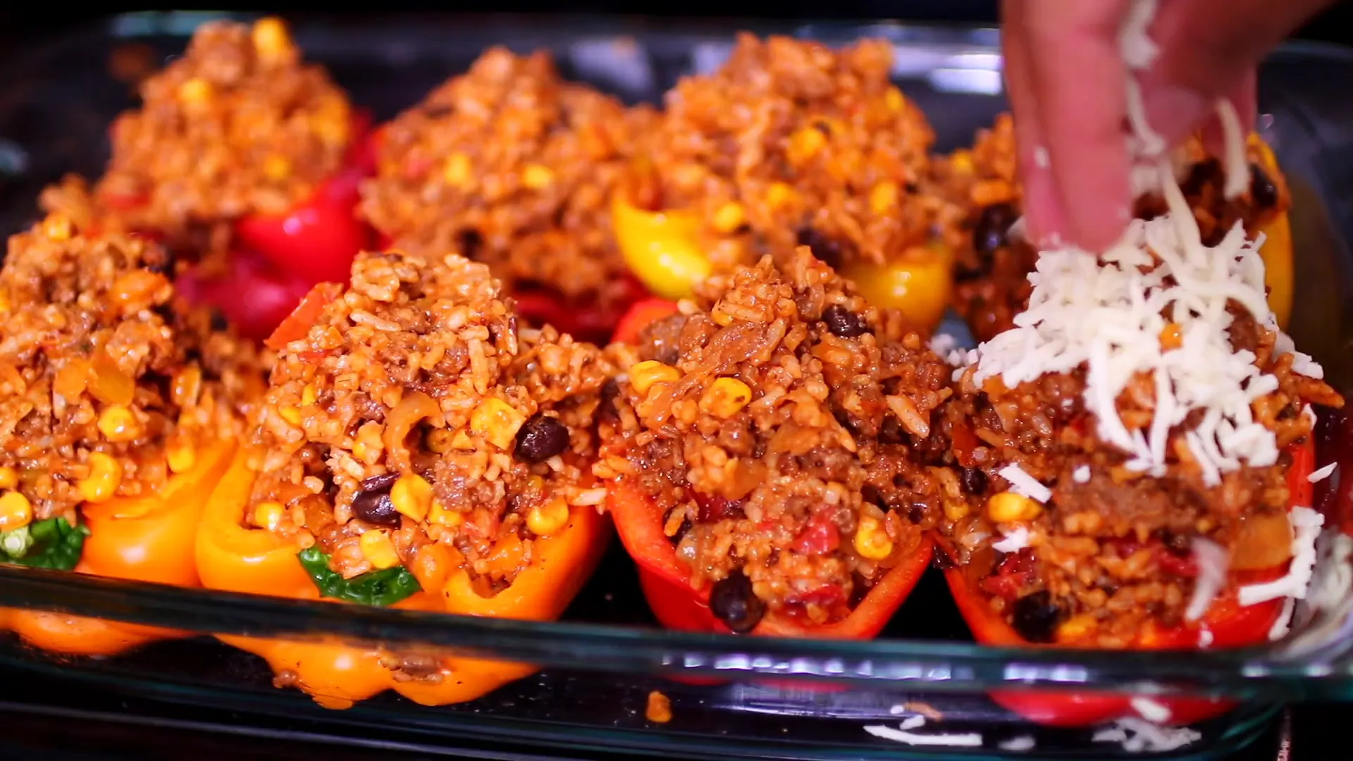 Stuffing the bell peppers with the beef and rice mixture.