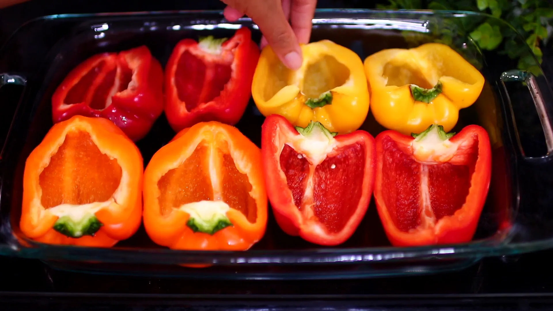 Drizzling olive oil and seasoning the bell peppers.
