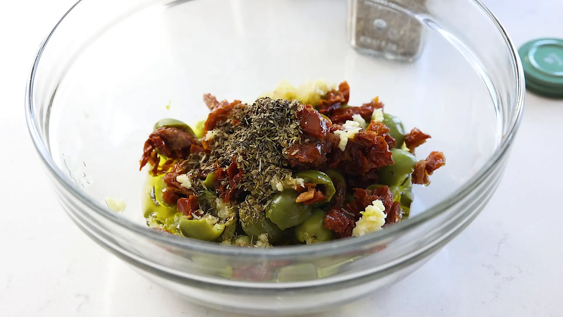 Adding dried herbs.