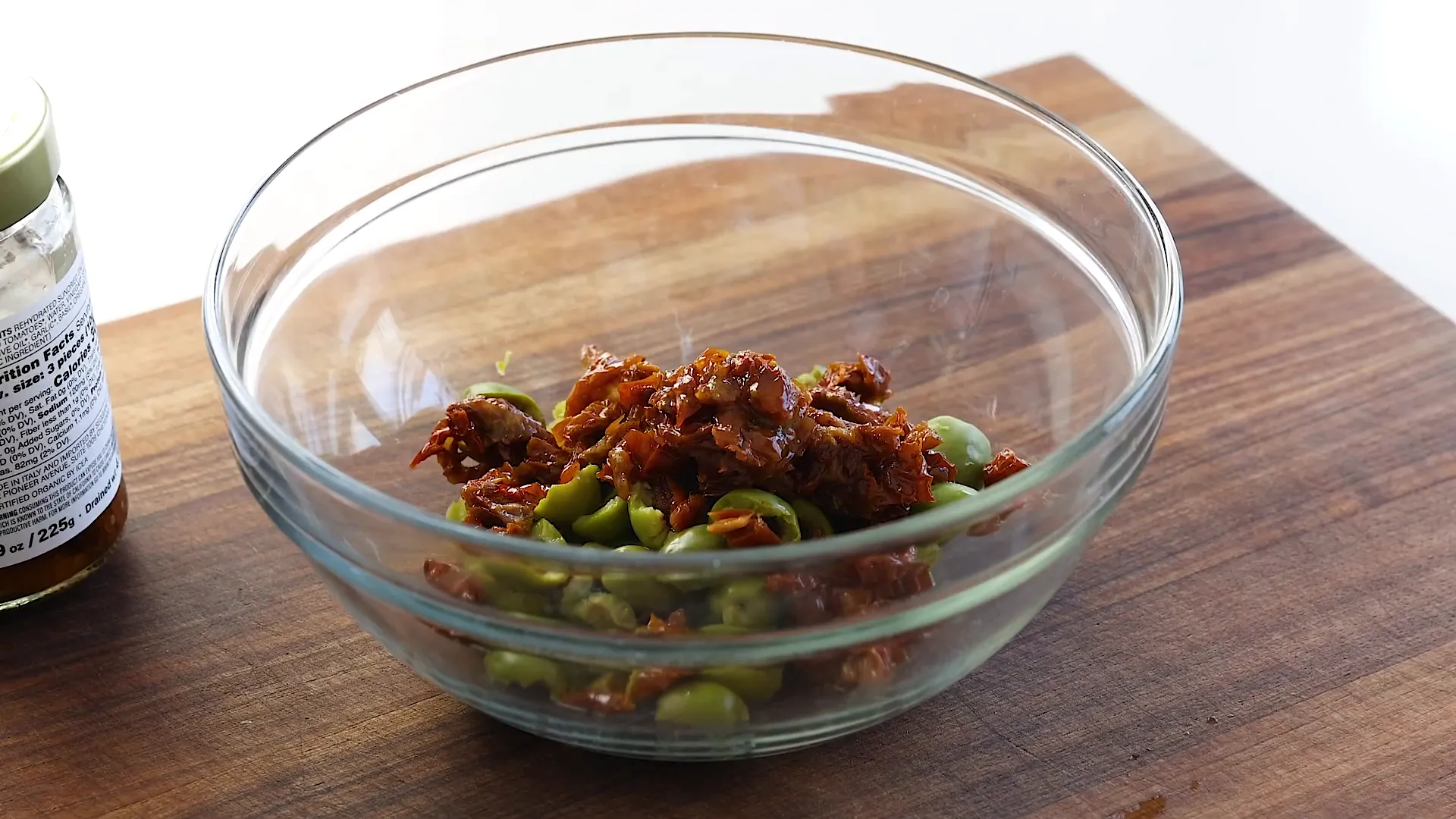 Mixing olives and sun-dried tomatoes.