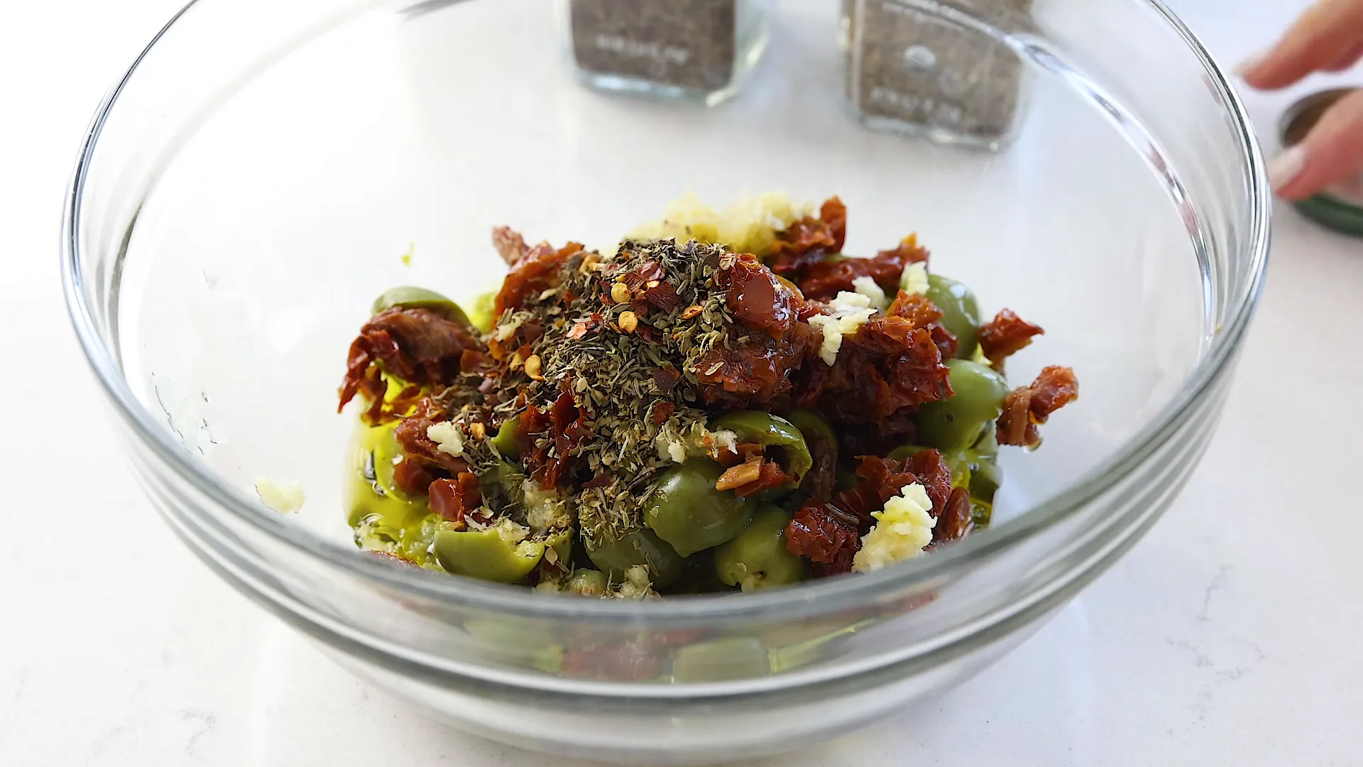 Adding red pepper flakes.