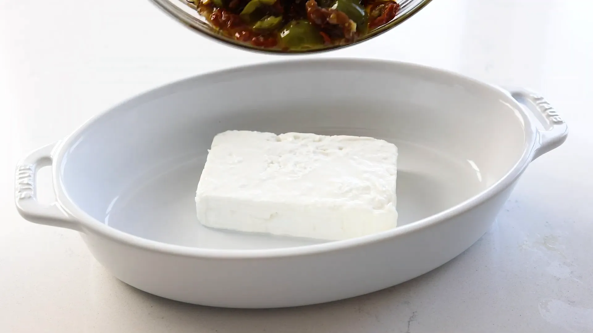 Placing feta in the baking dish.